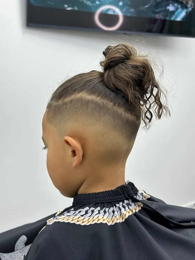 Kids haircut with a high fade, hair design and top knot in Denham Springs