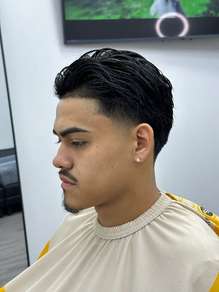 Textured comb-over with a low taper fade and crisp lineup